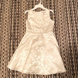 I am selling a white beautiful dress that has flowers On it and sparkly lace.